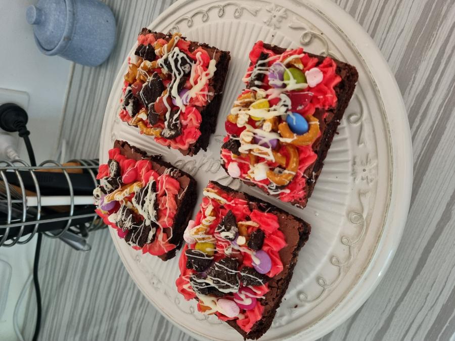 Chocolate brownie topped with vanilla buttercream, chocolate drizzle and an assortment of chocolates and lollies